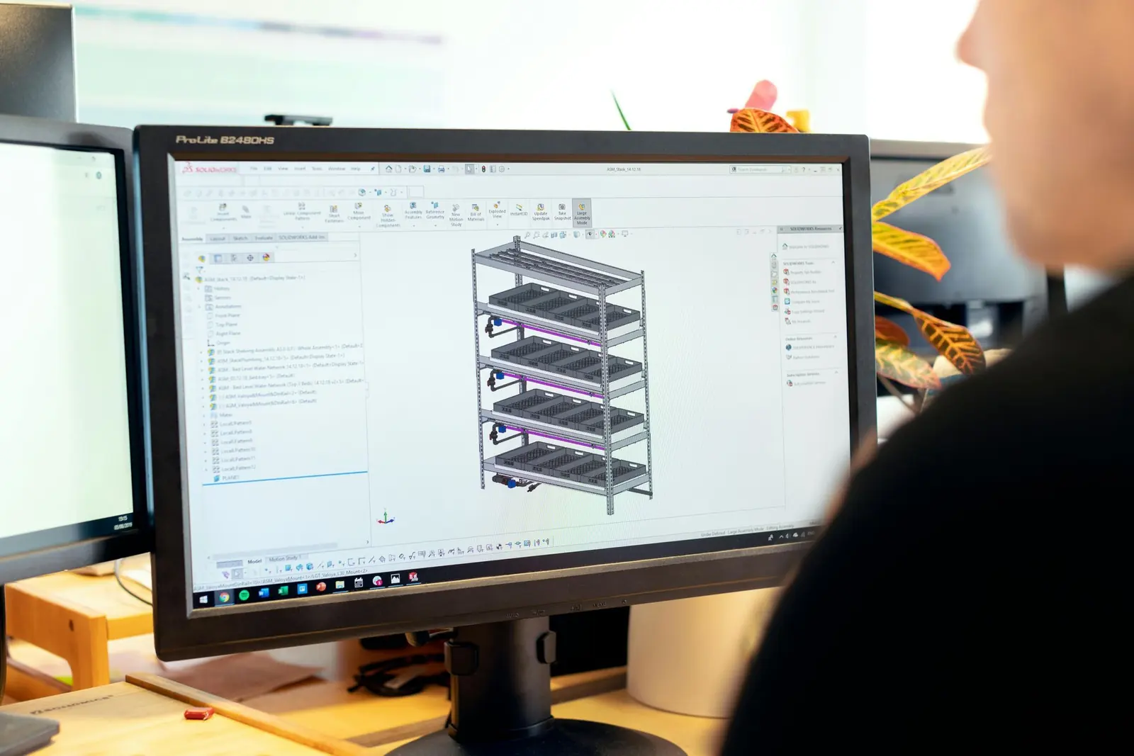 Engineer designing a server rack structure on screen